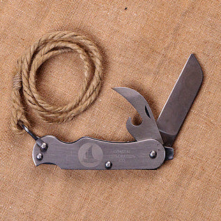 sailor's knife on a brown fabric background